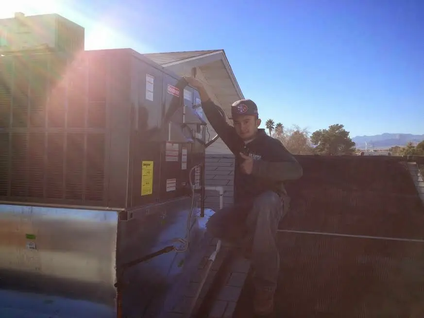 HVAC technician performing HVAC Inspection on a rooftop unit in Lago Vista